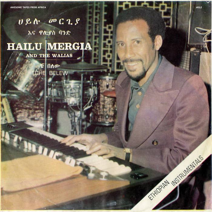 Album cover for "Hailu Mergia & The Walias - Tche Belew" by Tandem Coffee Roasters showing Hailu Mergia smiling and playing a keyboard. Text on cover includes album and artist.