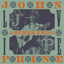 Album cover for John Prine - Live At the Other End, Dec. 1975 by Tandem Coffee Roasters features Prine playing guitar and singing, with ornate lettering and vintage decor—evoking a classic vinyl look like Sweet Revenge.