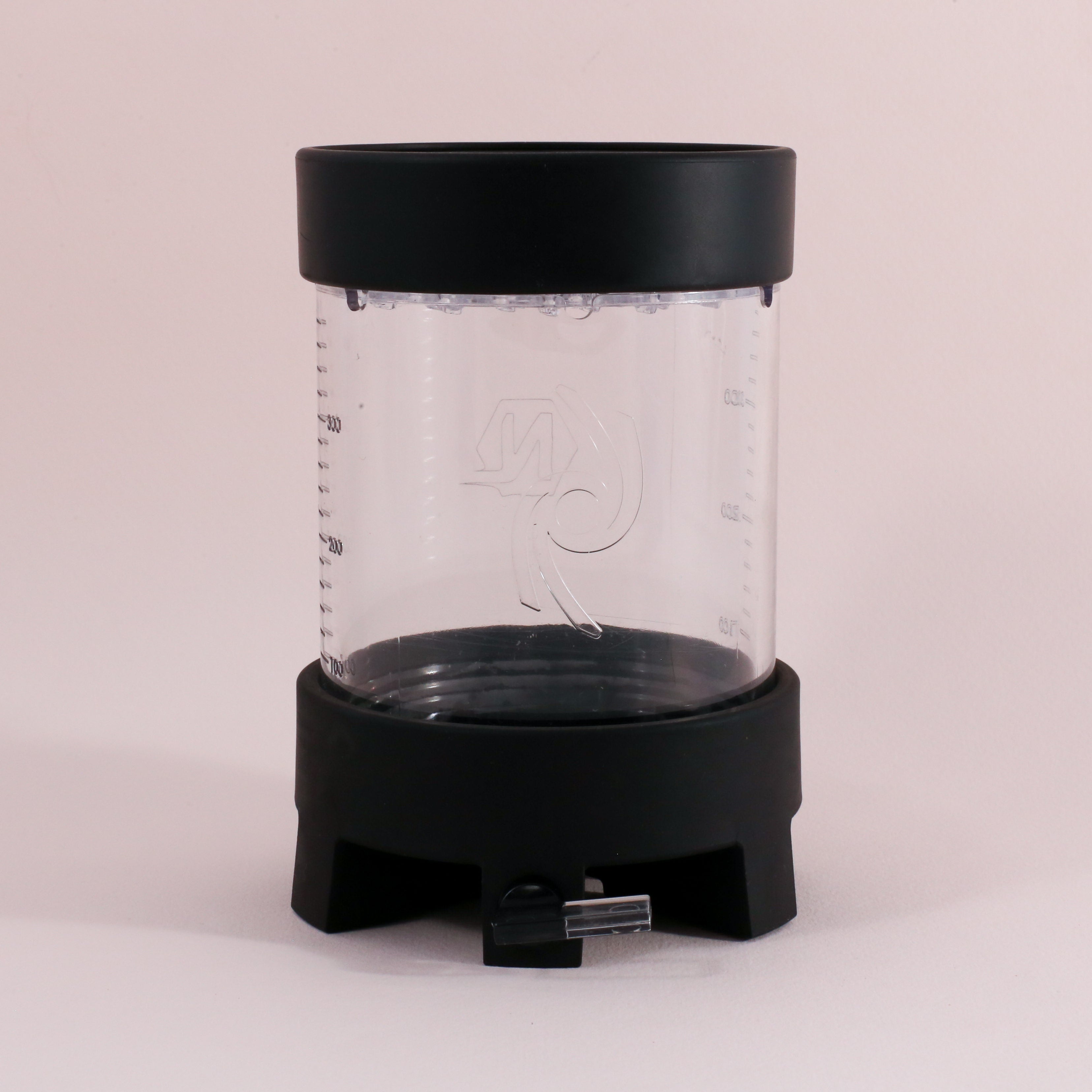 The Tandem Coffee Roasters NextLevel Pulsar Brewer is a clear cylindrical manual coffee maker with a black lid and base, spout at the bottom, adjustable flow valve, side measurement markings, and an etched logo on the front.