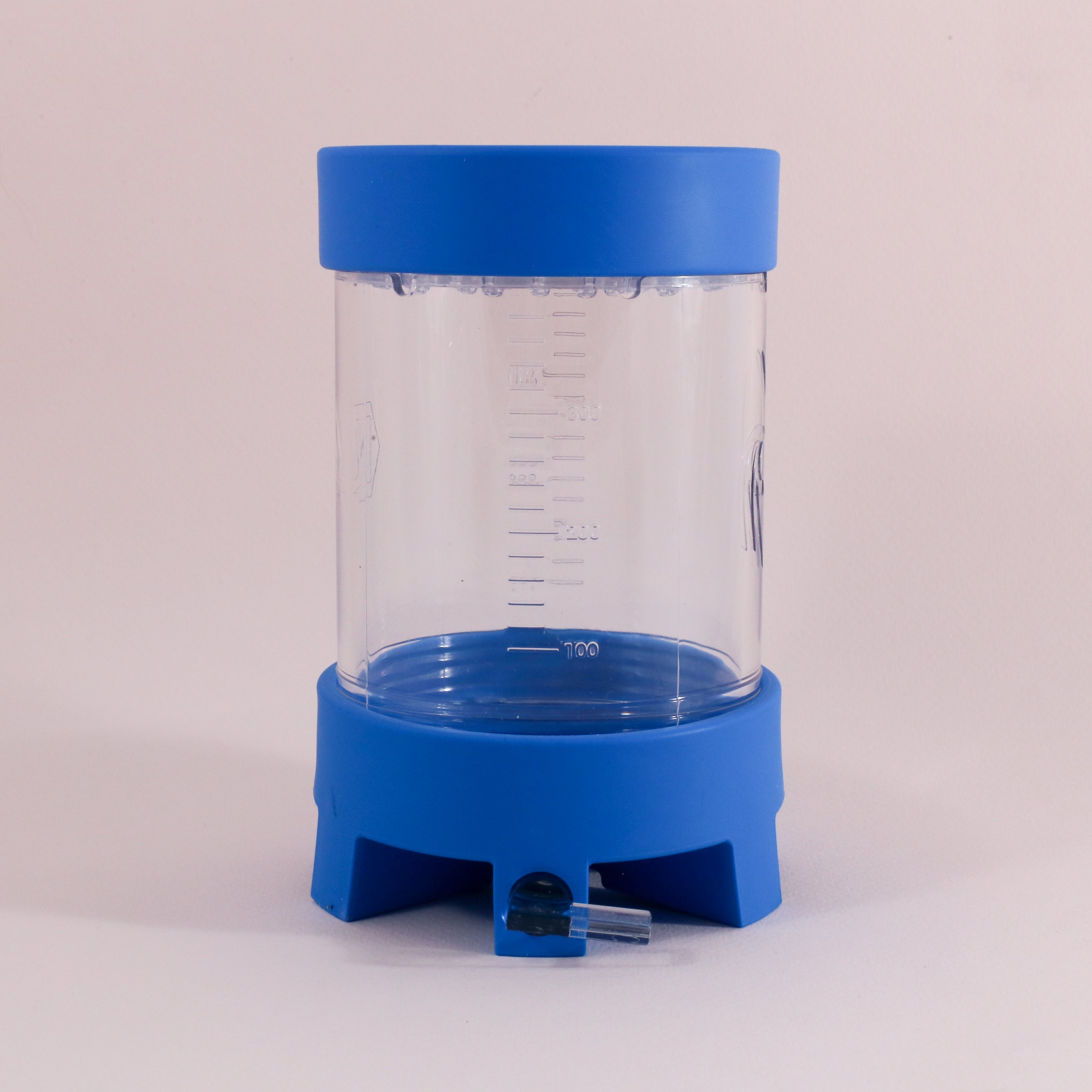 The NextLevel Pulsar Brewer by Tandem Coffee Roasters is a clear plastic container with a blue base and lid, measurement markings, and a bottom spout with adjustable flow valve for precise dispensing, shown on a plain light background.