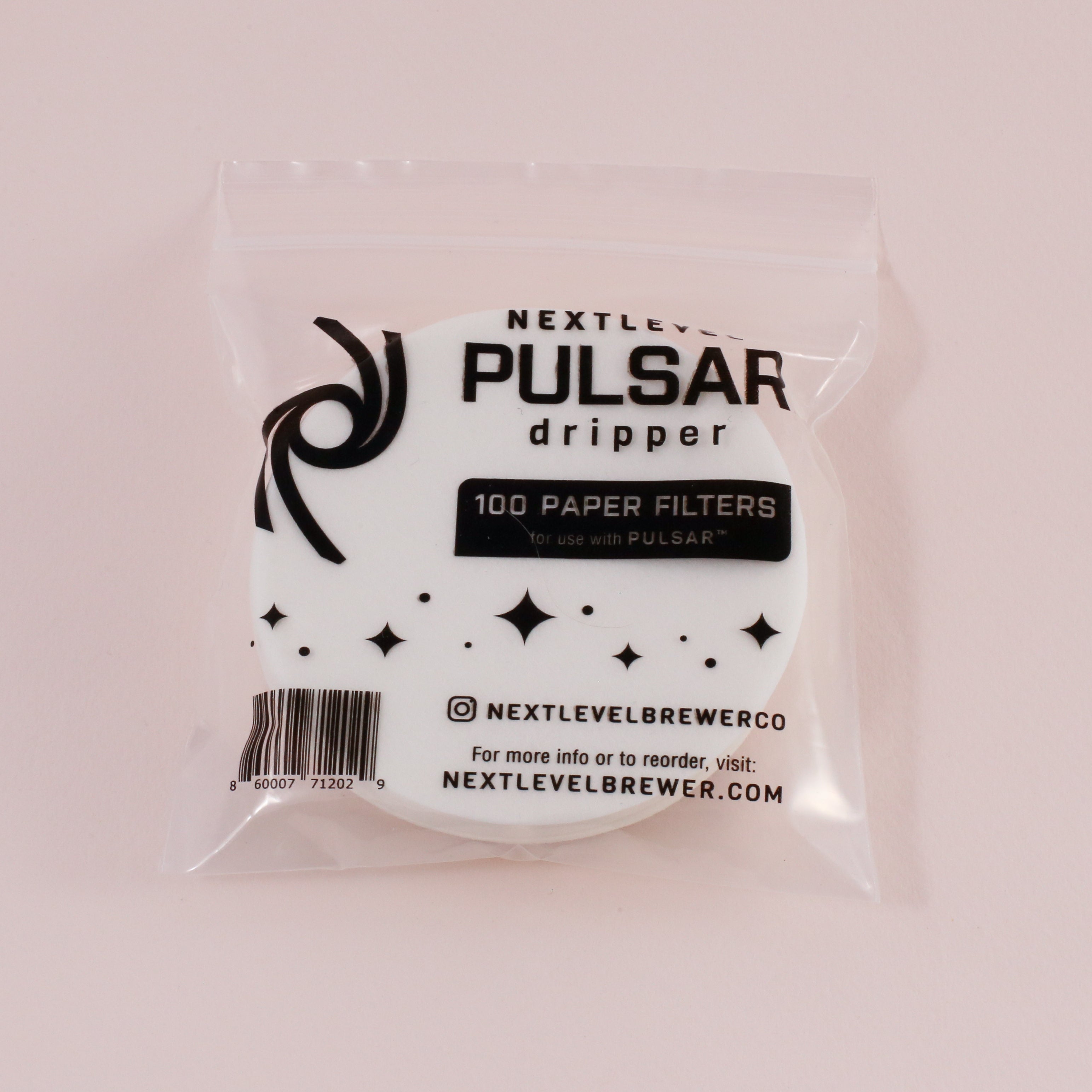 A clear plastic bag with black and white labeling contains round premium NextLevel Pulsar Filters from Hario. The package states 100 PAPER FILTERS for PULSAR use, and displays the Next Level Brewer logo and website.